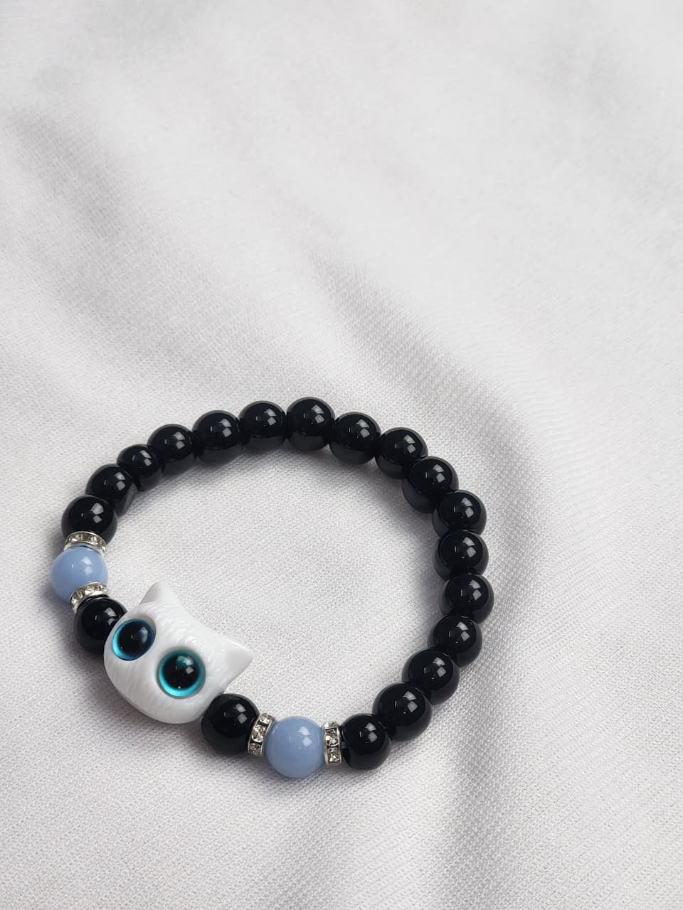 WhatsApp Image 2025-10-03 at 5.01.56 PM (3) Blue Eye Cat Bracelet – White Edition - Image 1